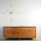 Wooden sideboard against a white wall with decorative elements.