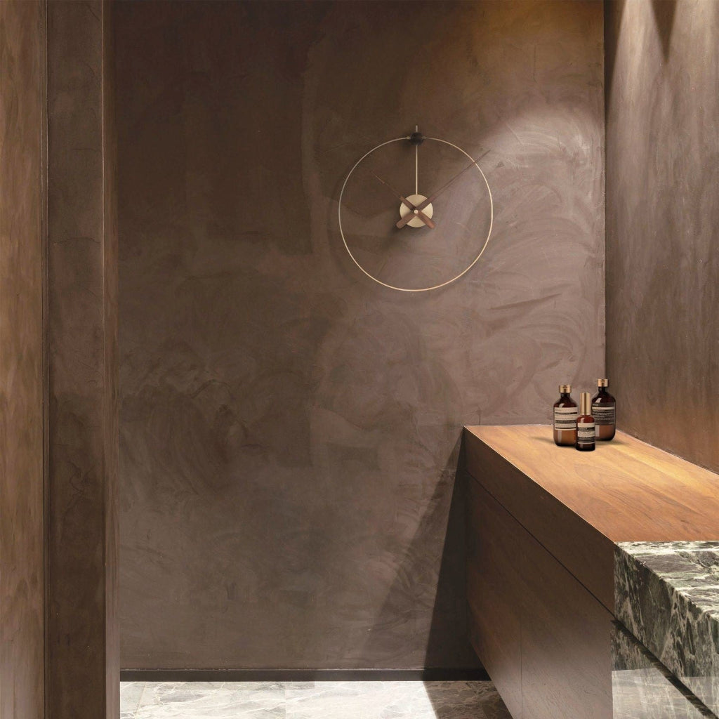 Modern bathroom with a wooden shelf against a textured wall.