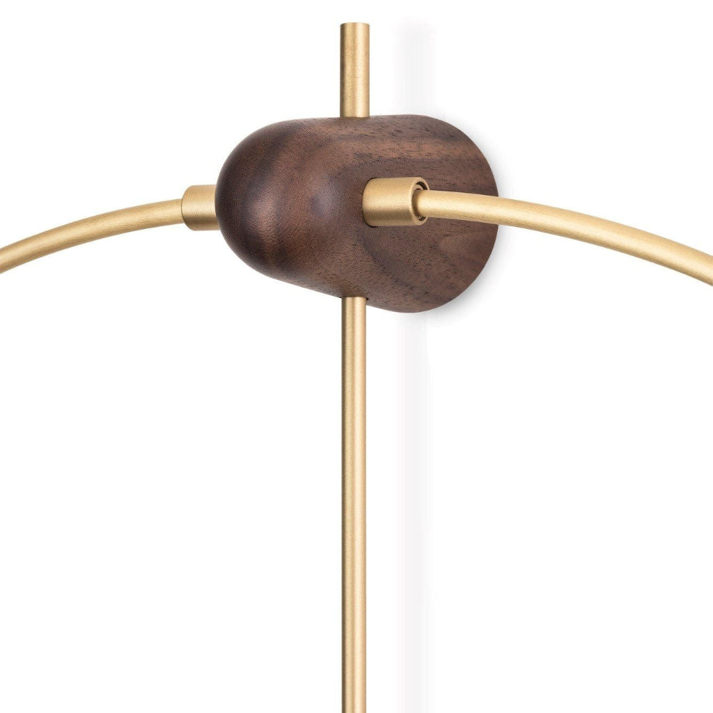 Wall-mounted light fixture with wooden base and gold metal arms on a white background