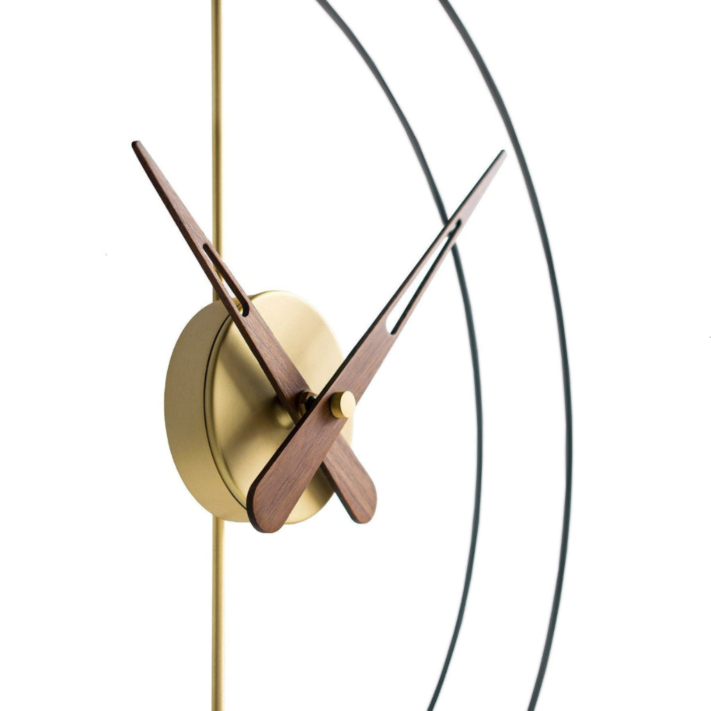 Modern wall clock with gold and wooden design on a white background
