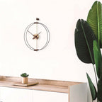 Modern clock on a wooden surface with a plant in the corner