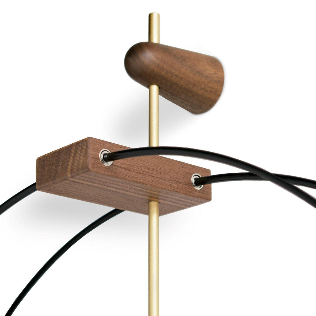 Wooden and brass pendant light fixture on a white background