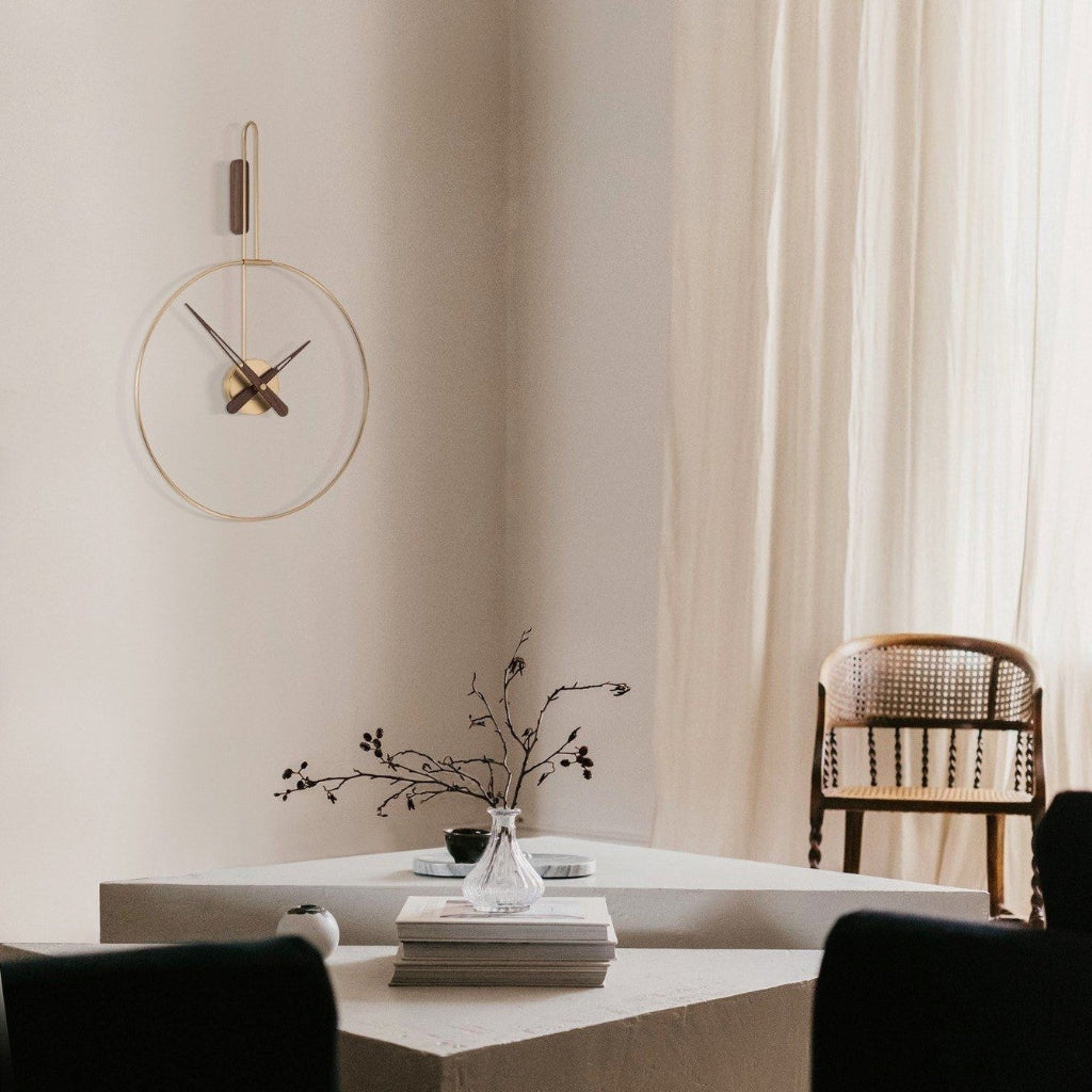 Modern interior with a wall clock, table, and chair in a softly lit room.