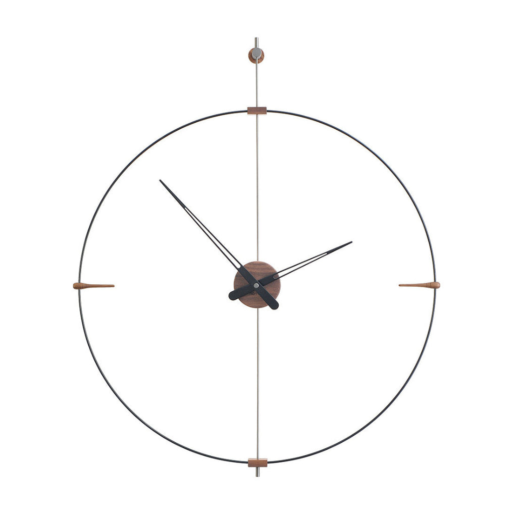 A Clock Nomon Mini Bilbao MBI with a sleek circular design hanging on a wall. available at Spacio retail stores in Mumbaii & Kolkata and online.