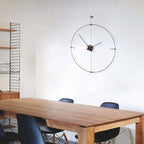 Wooden dining table with black chairs and a large wall clock in a minimalistic room.