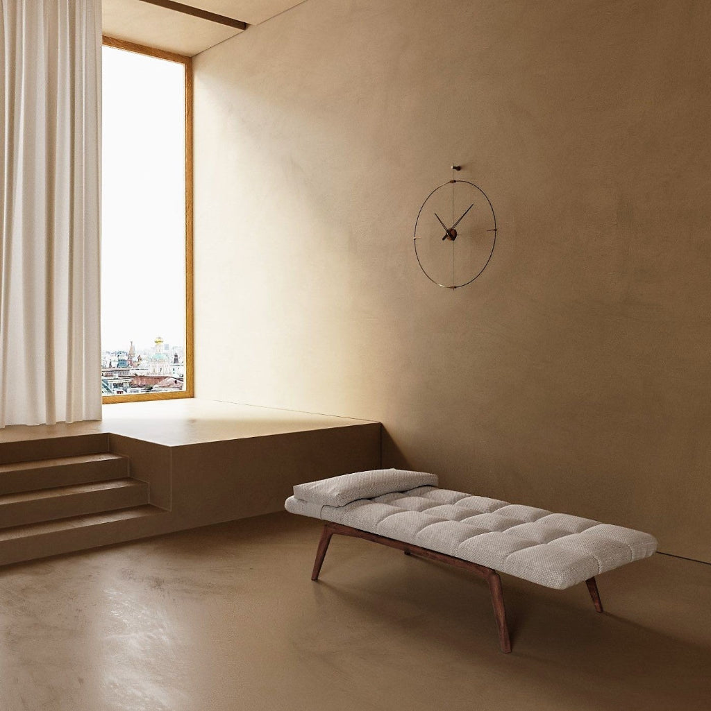 Minimalist room with a bed against a beige wall and large window.