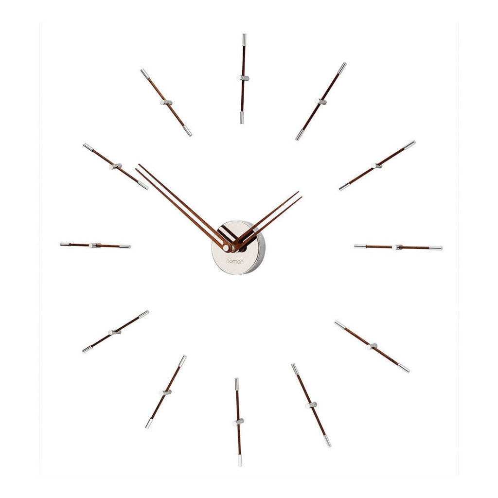 Modern wall clock with long thin hands on a white background