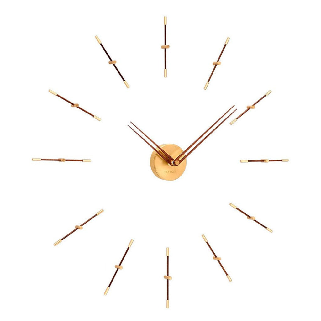 A Nomon Mini Merlin 12 Gold Walnut MMD120N wall clock with walnut wood hands and a large number of nails on it. available at Spacio retail stores in Mumbaii & Kolkata and online.
