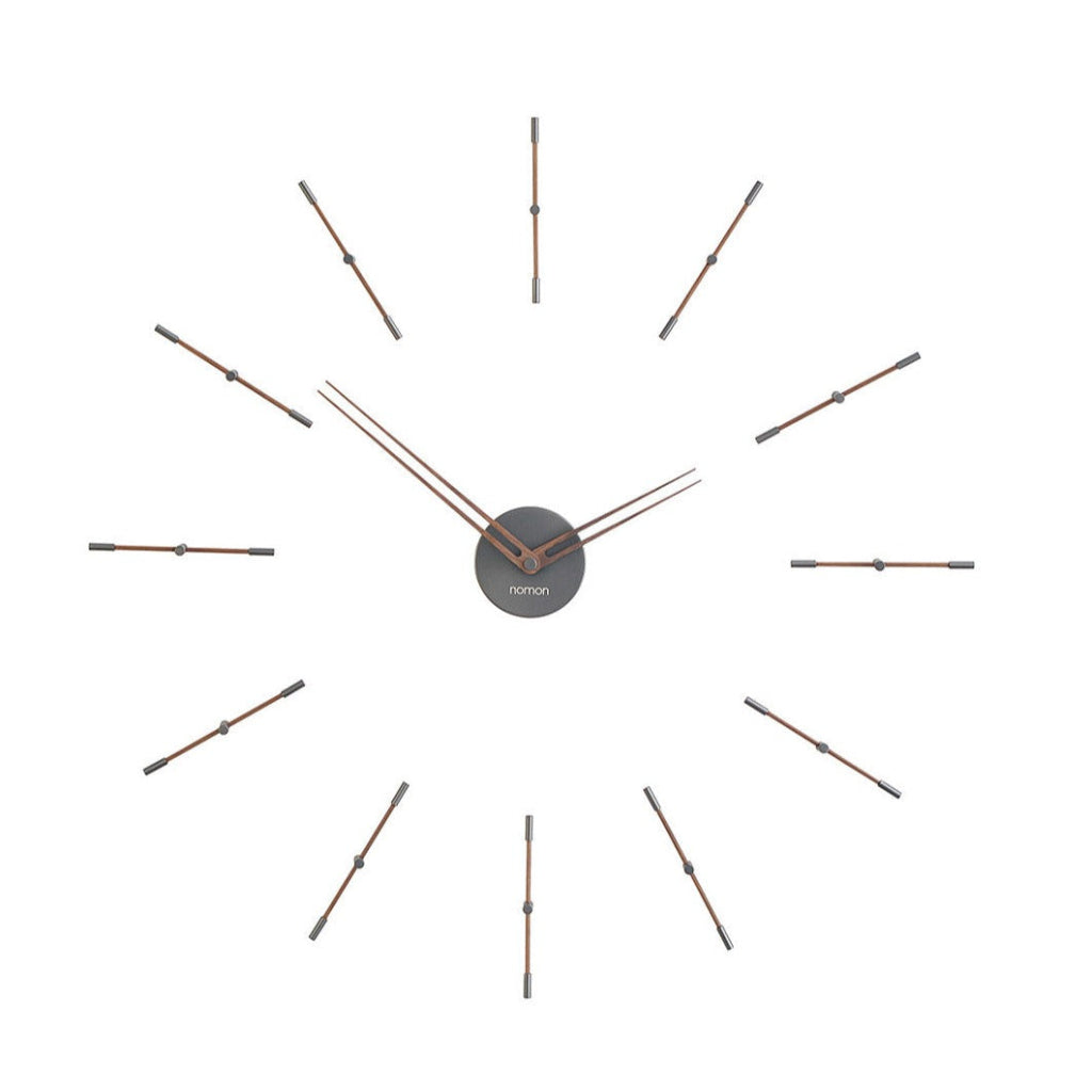 An elegant Nomon clock with metal rods on a white background. available at Spacio retail stores in Mumbaii & Kolkata and online.