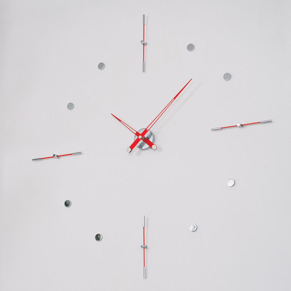 Modern wall clock with red and silver design on a light gray background