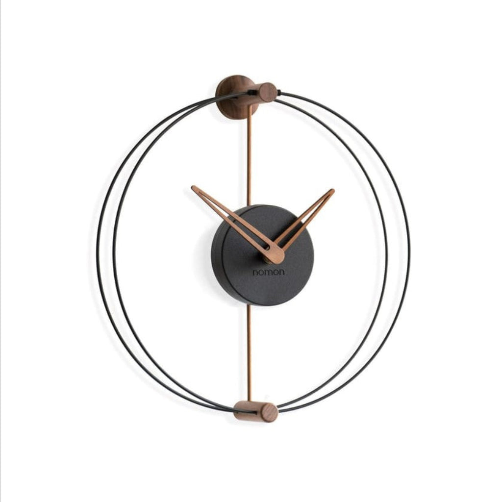 Modern wall clock with black and bronze design on a white background