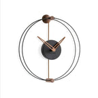 Modern wall clock with black and bronze design on a white background