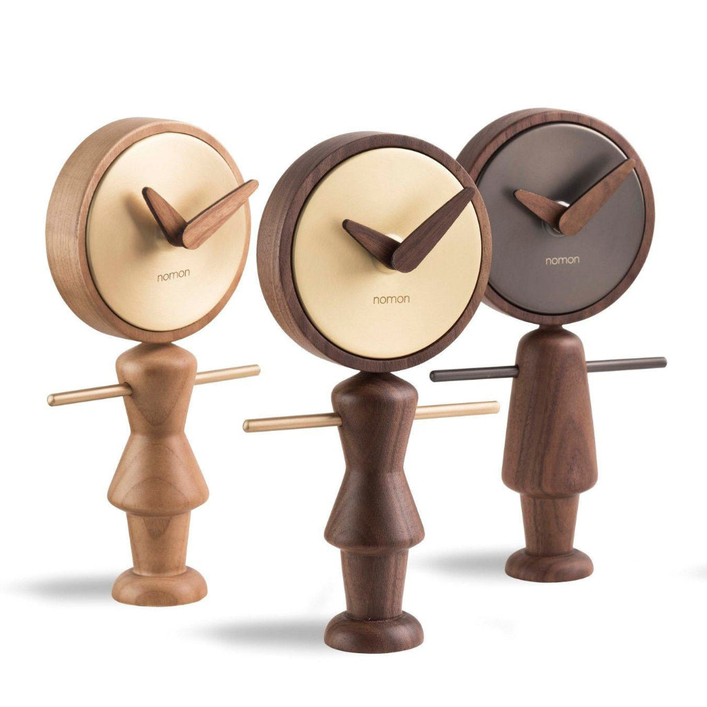 Three wooden clock figures with different color faces on a white background