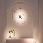 Decorative wall clock on a wall with a plant and books below