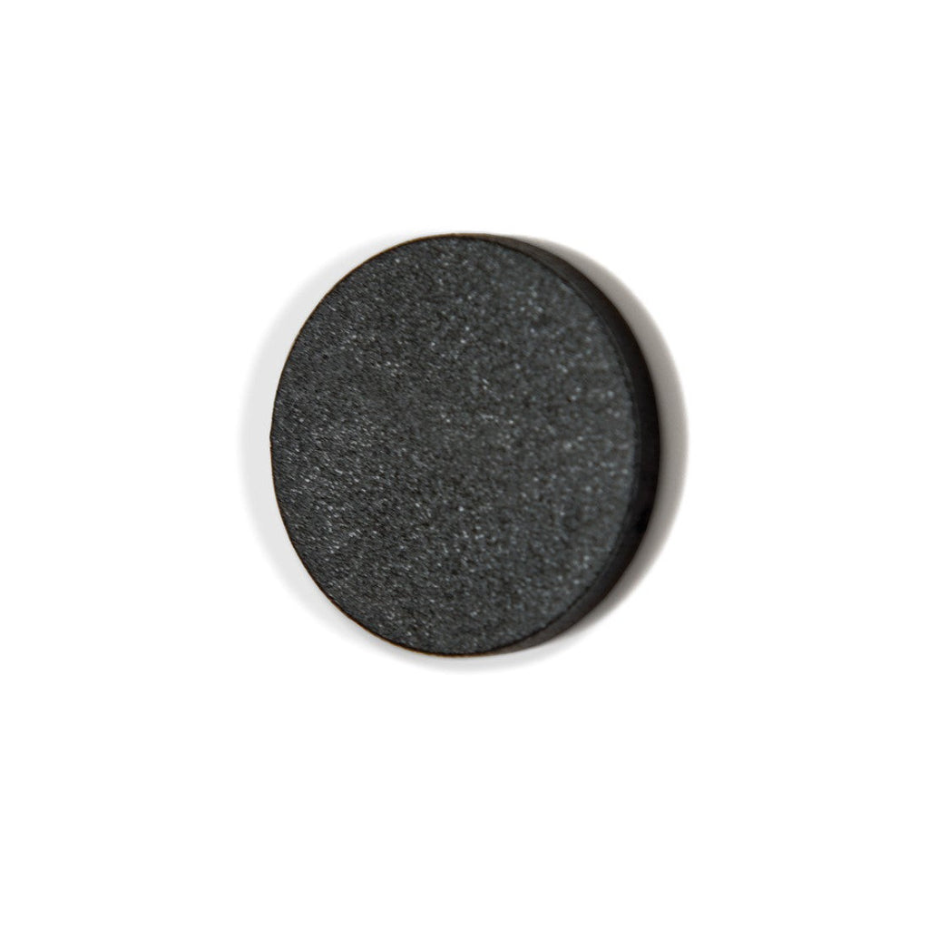 Round black stone on a white background