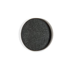 Round black stone on a white background