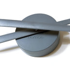 Gray wall light fixture with 'nomon' branding on a white background