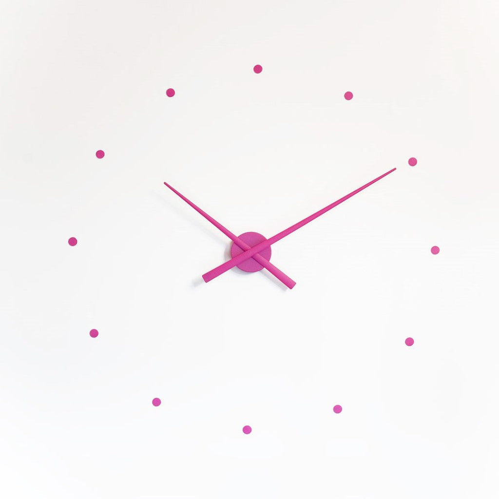 Pink wall clock with minimal design on a white background available at Spacio retail stores in Mumbaii & Kolkata and online.
