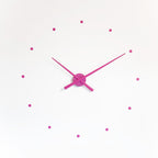 Pink wall clock with minimal design on a white background available at Spacio retail stores in Mumbaii & Kolkata and online.