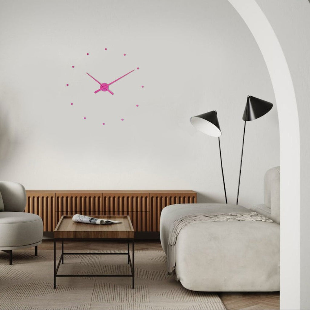 Modern living room with a pink wall clock, wooden side table, and gray sofa.