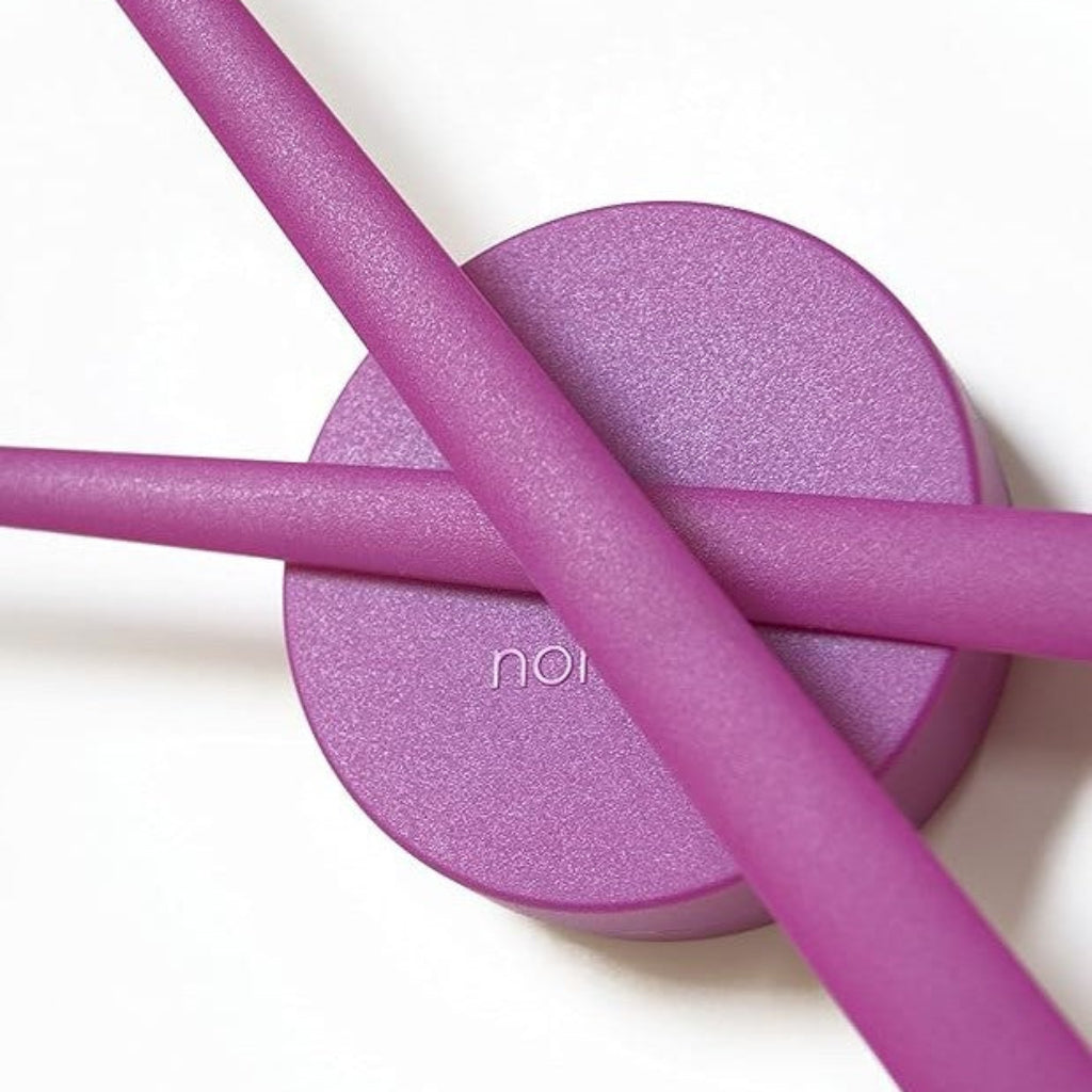 Purple makeup sponge and applicator on a white background with 'nai' branding.