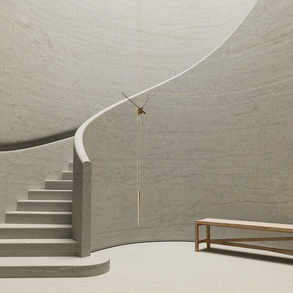 Modern architectural interior with curved wall, staircase, and bench.