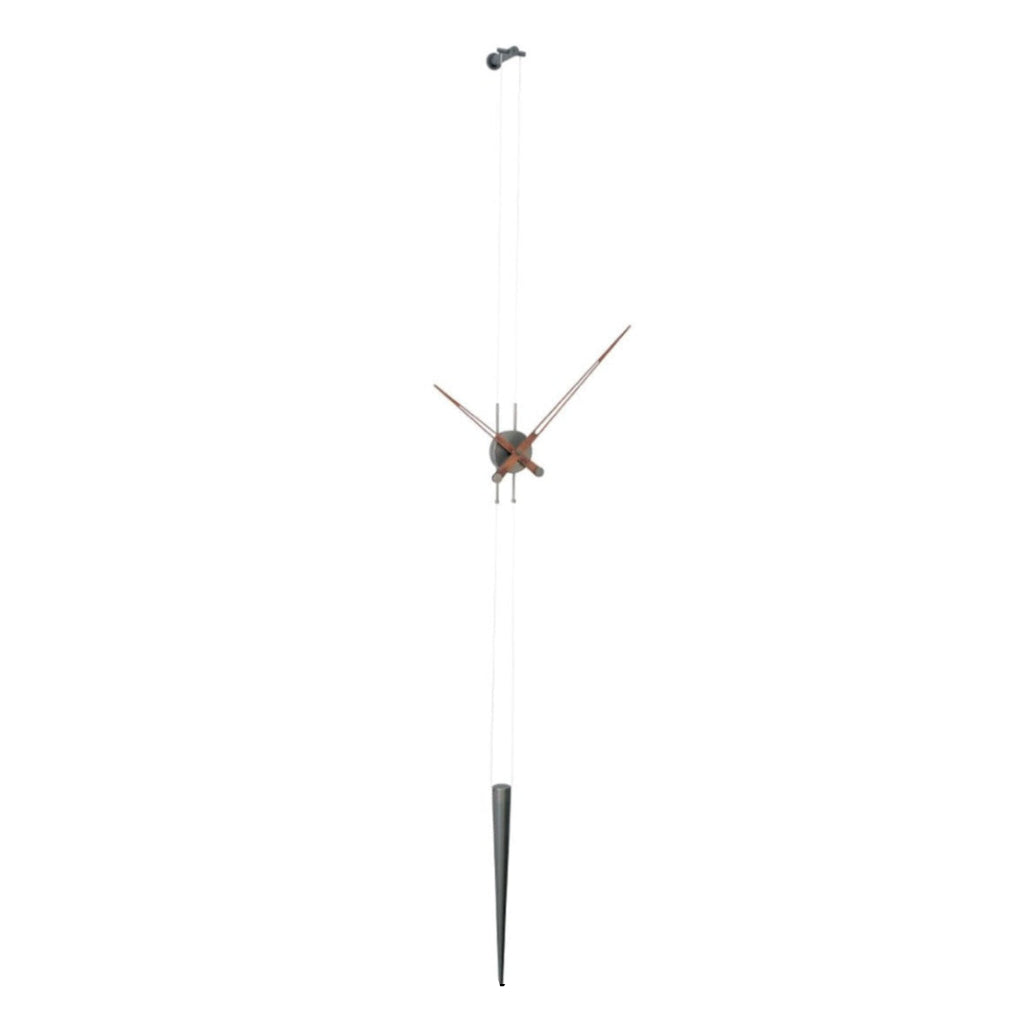 A stylish Nomon clock on a pole with a unique Clock Nomon Pendulo T - Walnut PET0000N clock face design. available at Spacio retail stores in Mumbaii & Kolkata and online.