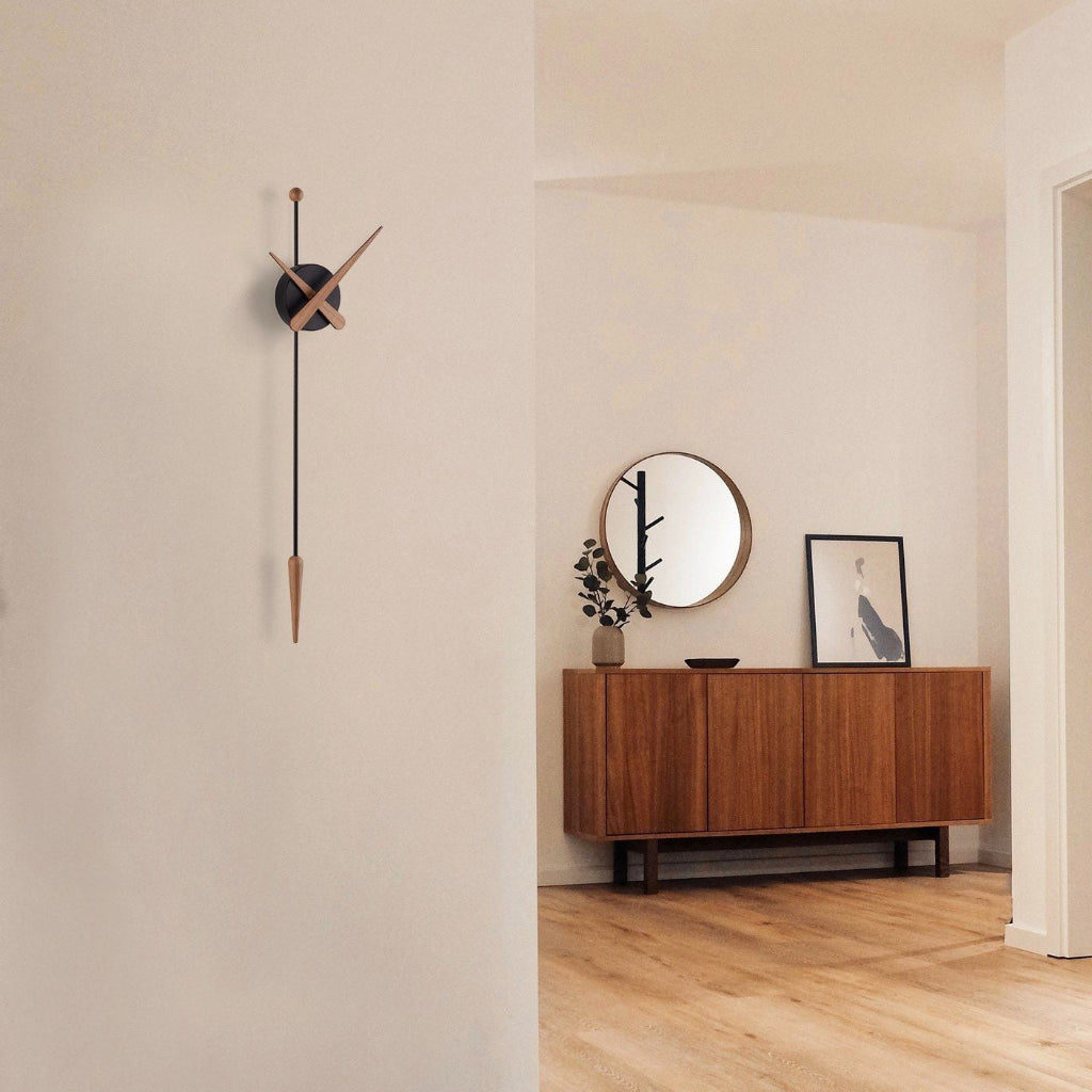 Modern interior with a wooden sideboard, round mirror, and wall clock.