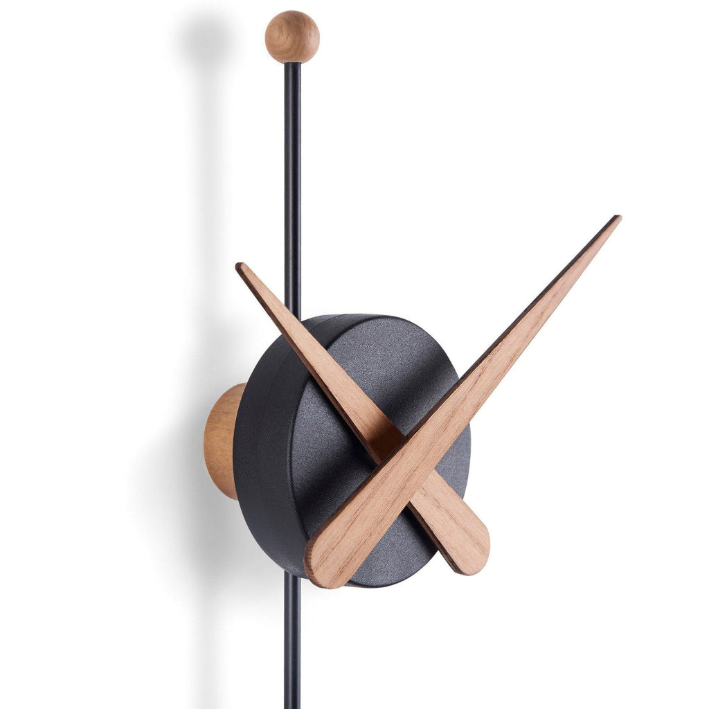 Modern wall clock with black and wood design on a white background