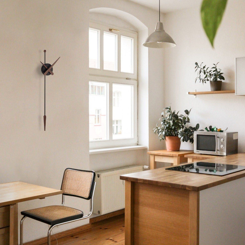 Small kitchen with wooden island, chair, and window