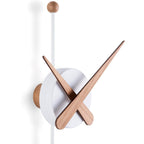 Modern wall clock with wooden arms on a white background