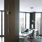 Modern office with a desk, computer monitors, and chairs.