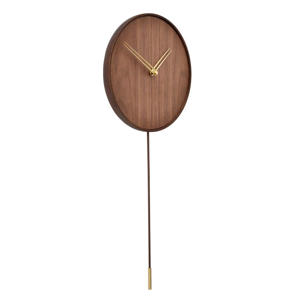 Wooden wall clock with a long pendulum on a white background