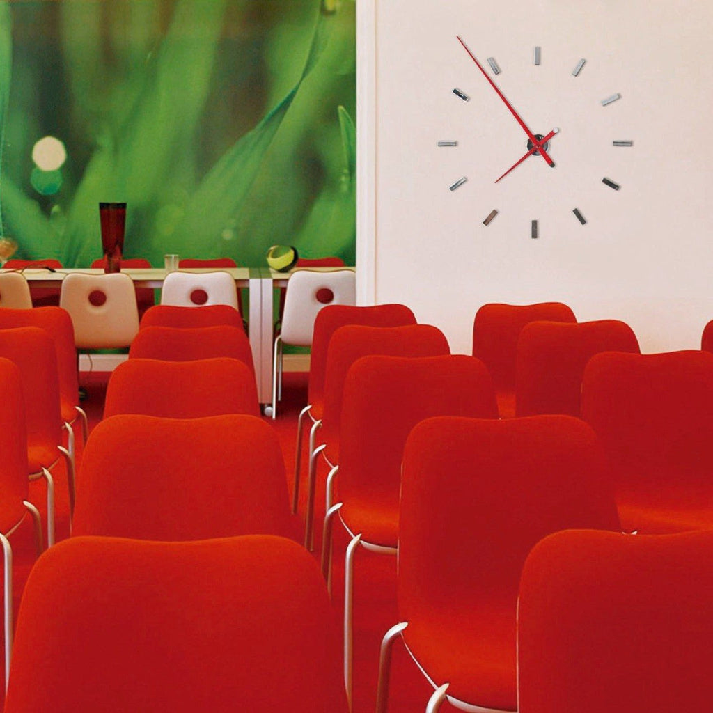 Nomon Spain Tacon L 12 Red on a white wall behind red chairs of auditorium available at Spacio India for luxury home decor collection of Timepieces & Clocks.