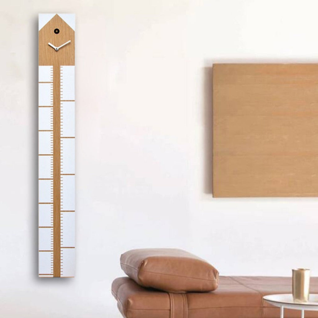 Wooden growth chart on a wall next to a brown sofa