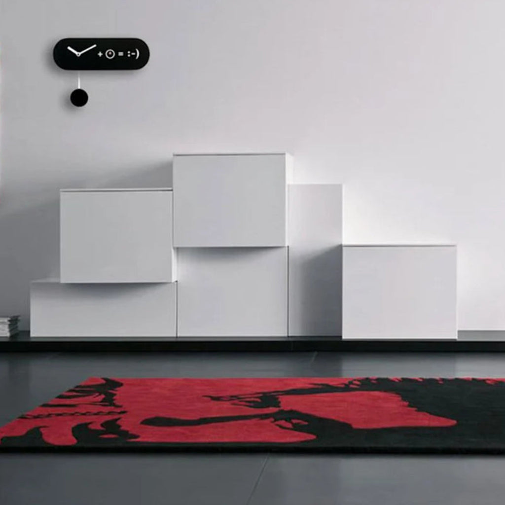 Modern interior with white furniture and a red and black rug.