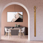 Modern interior with a TV mounted on a wall, a dining table with chairs, and a decorative wall clock.