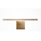 Metallic gold sample with a ruler for scale on a white background