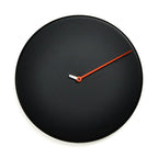 Black wall clock with a red second hand on a white background from Progetti available at Spacio retail stores in Mumbaii & Kolkata and online.