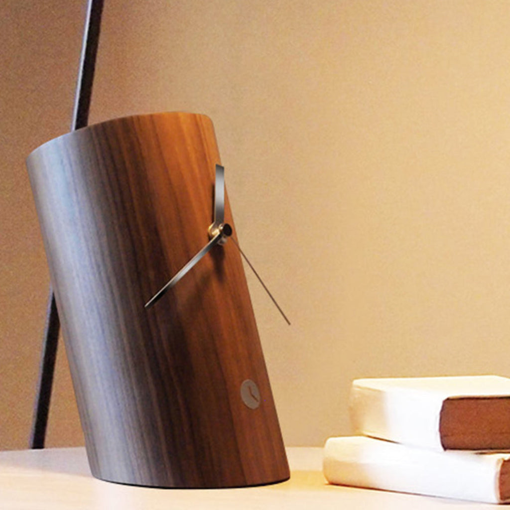 Wooden lamp with metallic accents on a surface with a soft background